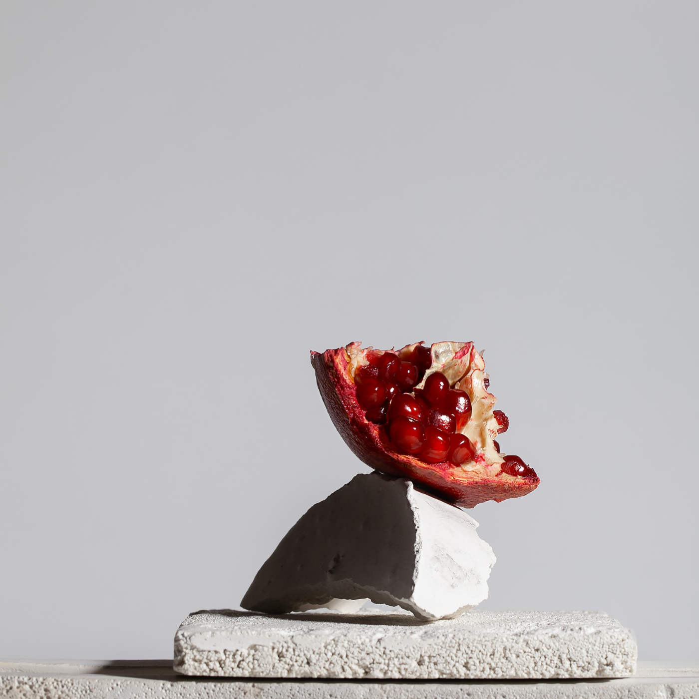 pomegranate balancing on concrete