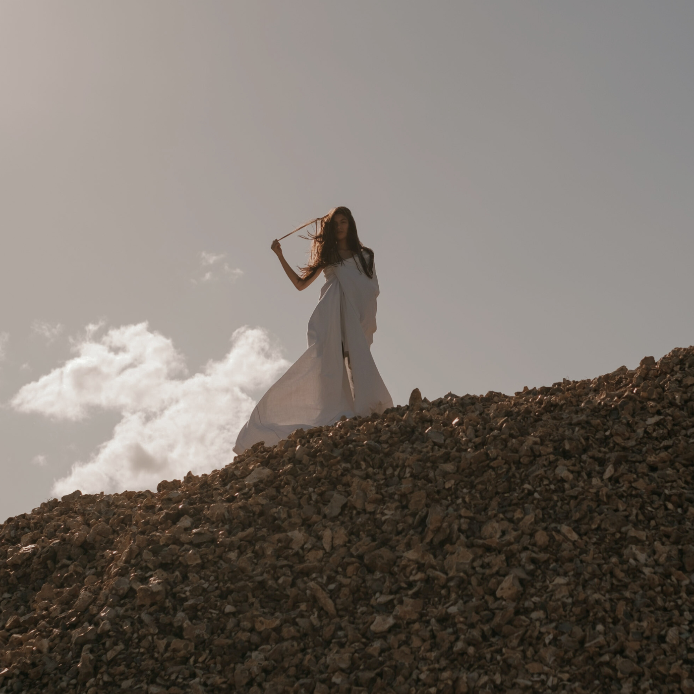 Woman standing on top of a hill looking down